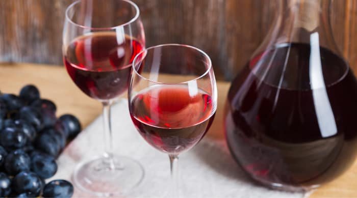 Red wine is an alcoholic beverage made from the fermented juice of dark-skinned grapes. 