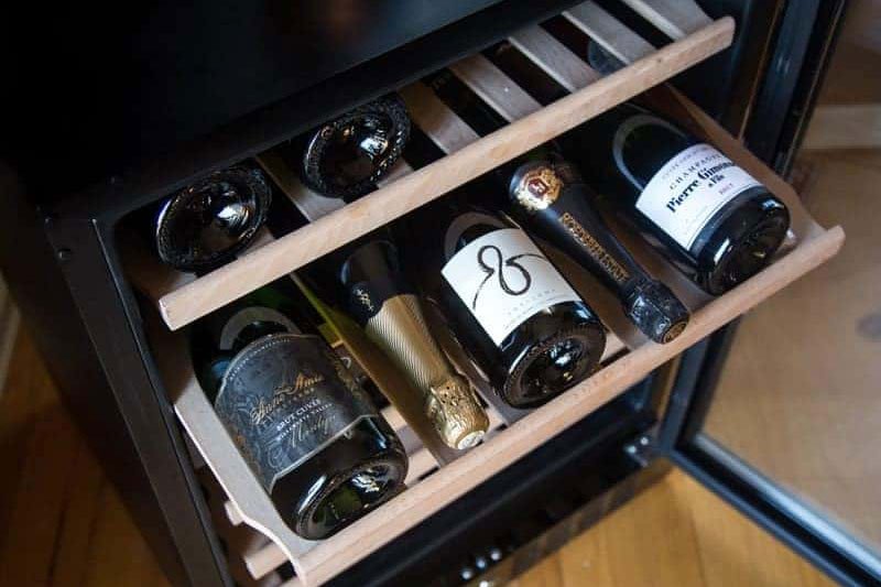 Typically, in a dual zone wine cooler, the lower area will have a cooler temperature range for white wines, and the upper area would have a higher temperature range for red wines.