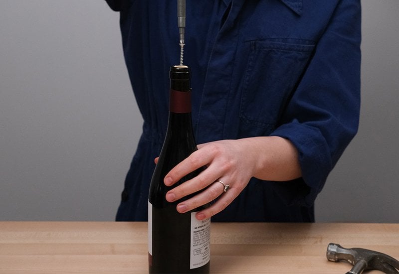 The screwdriver method requires three tools - a long screw, a hammer, and of course - a screwdriver. Here’s how you can open your wine bottle: