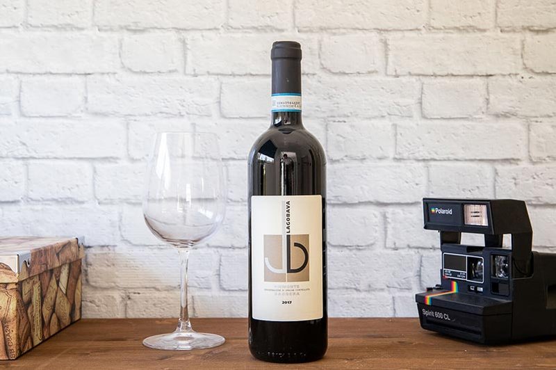 Piemonte Barbera wine bottle and glass.