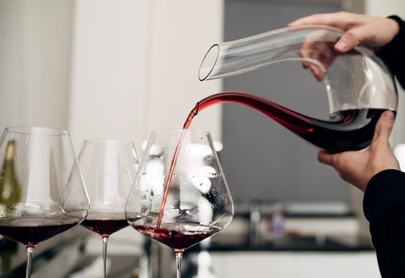 To decant, pour the wine from the bottle into a decanter and allow it to aerate. 