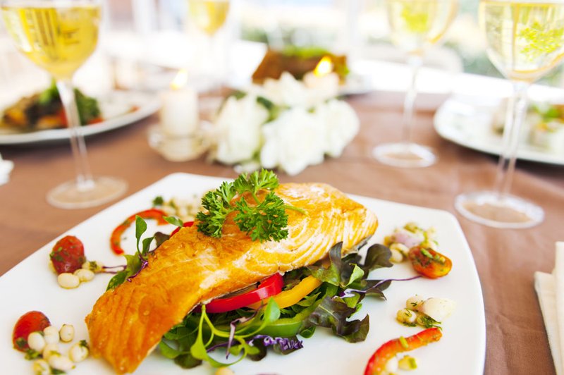 White wine paired with salmon and greens.